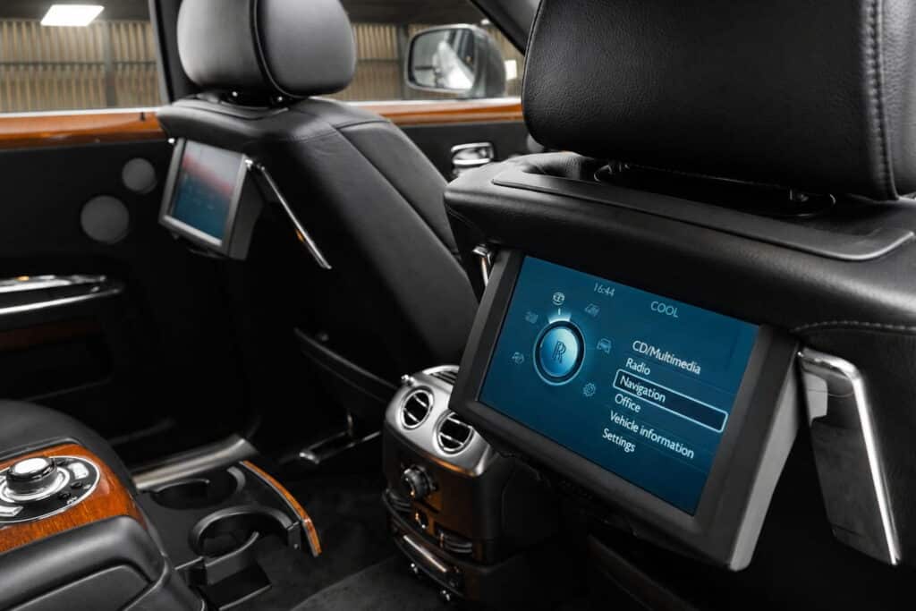 คอนโซลหลัง Rolls-Royce Ghost 2015 พร้อมจอความบันเทิงและโต๊ะปิกนิก | Rear console of the Rolls-Royce Ghost 2015 with entertainment screen and picnic table